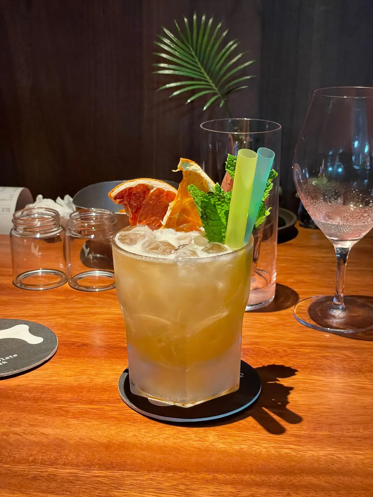 A pale cocktail over crushed ice with dried grapefruit, orange and mint at Chocolate+Milk